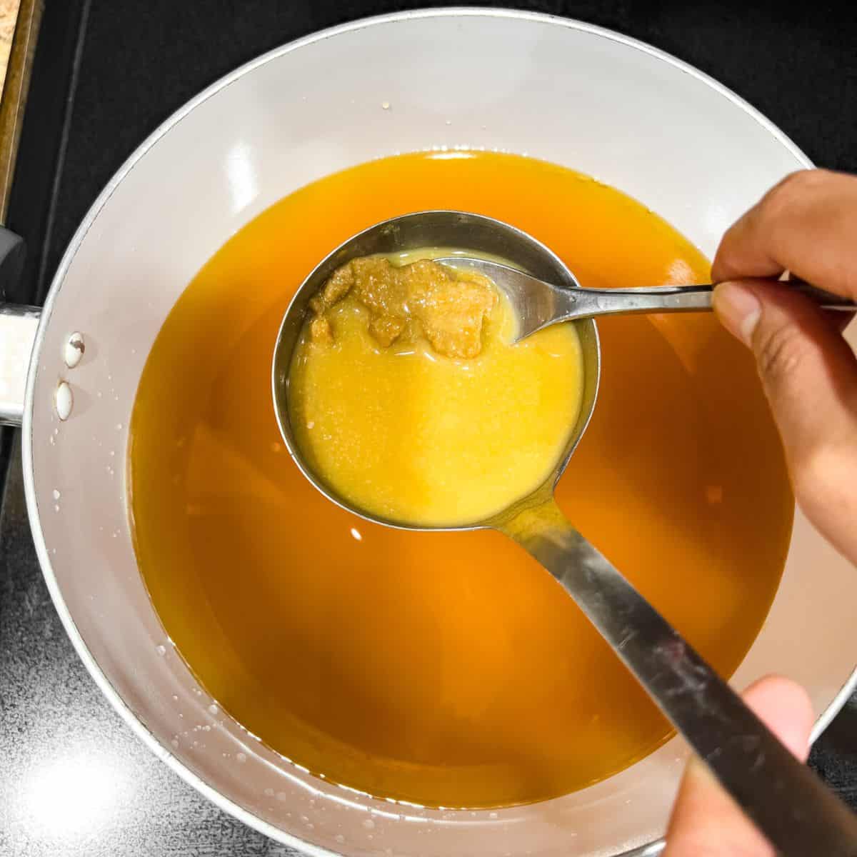 Dissolving soybean paste to make a soup.