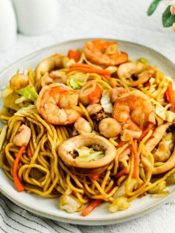 Finish dish of pancit canton with seafood on a plate.