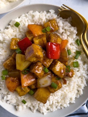 Finish dish of easy sweet and sour tofu with rice on a plate.